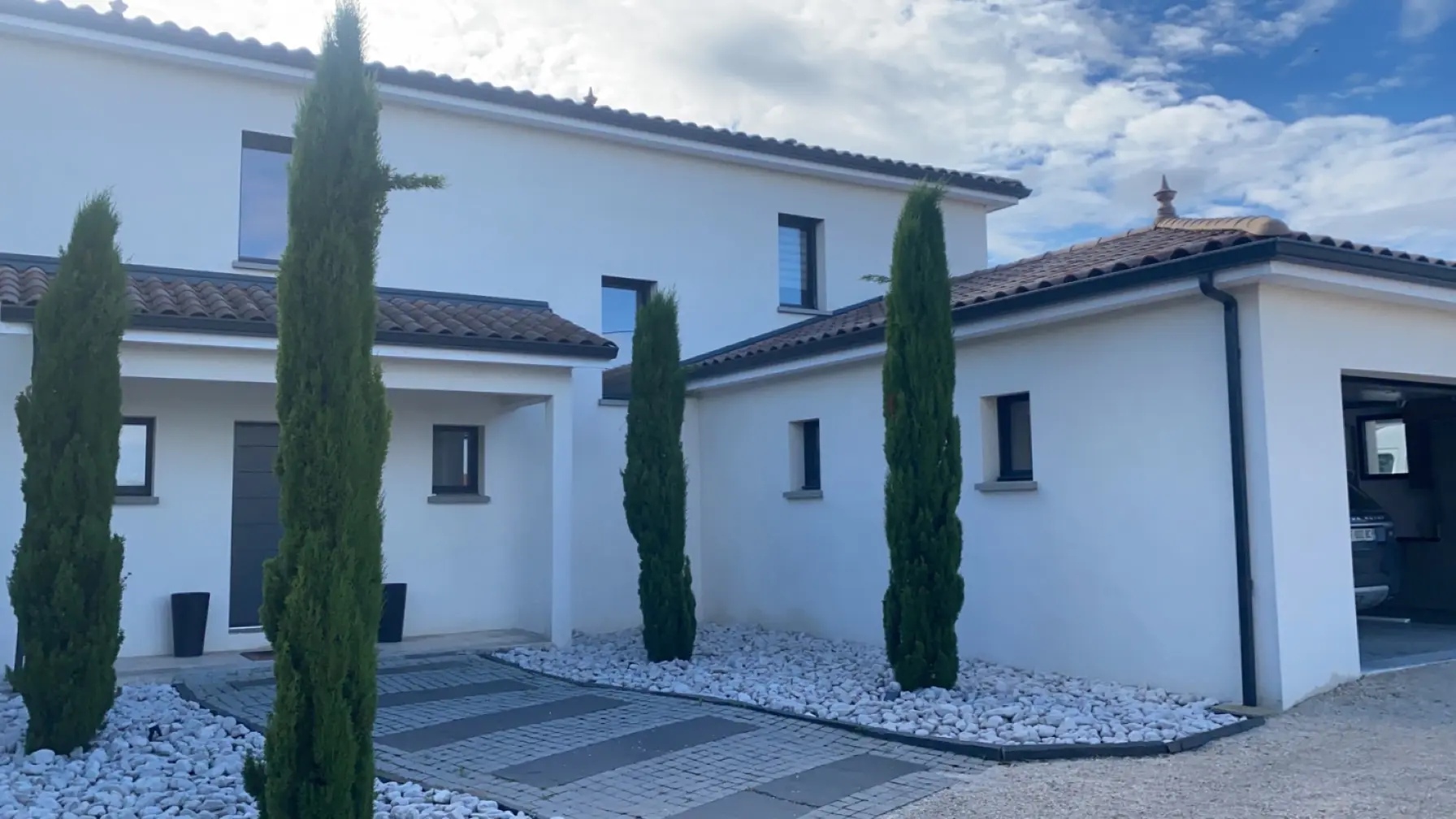 Maison contemporaine blanche avec arbuste, l'ensemble est tres propre